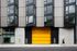 the oro apartment building with yellow garage door