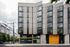Studios in Downtown Portland OR - ORO - An exterior shot of The Apartment Building with Black, Yellow, and Grey Details and Many Windows