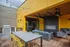 Slabtown OR Apartments - ORO - Rooftop Lounge With Fireplace, Plush Seating, Chairs, Tables, String Lights, And BBQ Grill.