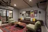 Apartments Near Portland State University - ORO - Lounge with Industrial Style Furniture, Wall Art, and Red Area Rug