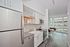 Luxury Apartments in Pearl District, OR - ORO - A Kitchen with a Stainless Steel Refrigerator, Microwave, Oven, Dishwasher, and Farmhouse Sink.