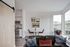 Downtown Portland, OR Luxury - ORO - ApartmentsLiving Room With Wood-Style Flooring, High Ceilings, Large Windows, A Brown Leather Sofa, And A Dining Area With A 2-Person Table