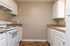 Kitchen with White Cabinets & Brown Counters