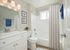 spacious bathroom with white cabinets and soaking tub