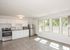 newly renovated kitchen with stainless steel appliances and modern wood style flooring