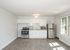newly renovated kitchen with stainless steel appliances and modern wood style flooring