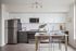 Kitchen with quartz countertops and stainless steel appliances and dining area