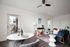 Living and dining room area with wood-inspired flooring and ceiling fan
