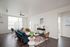 Living room with ample natural light and luxury wood-inspired flooring