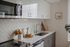 Kitchen with stainless-steel appliances, quartz countertops and subway tile backsplash