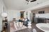 Living room and kitchen area with open-concept floorplan, luxury plank flooring and stainless steel appliances