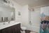 Bathroom with grey cabinets and quartz countertops