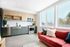 open kitchen with stainless steel appliances and vinyl wood like flooring at novus woodstock apartments