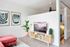 living room with red sofa, vinyl wood like flooring and tv console at novus woodstock apartments