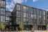 exterior front of 4 story artisan apartment building