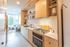 galley kitchen with birch wood cabinets at artisan