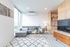 living room with grey sofa and white area rug at