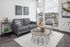 living room with grey sofa and round coffee table with vinyl wood like flooring at parallax apts