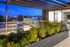 Apartments In Williams District For Rent - Rooftop Lounge That Has A Fire Pit, Chairs, And Decorative Plants.