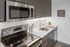 kitchen with stainless steel appliances and vinyl wood like flooring at aniva apartments