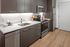 kitchen with stainless steel appliances and vinyl wood like flooring at aniva apartments