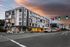 4 story aniva apartment building with the sun setting in the backgroun