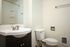 bathroom with dark cabinets