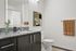 Virtually staged bathroom with espresso cabinets and granite countertops