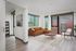 Virtually staged living room and bedroom with wood-style flooring and floor to ceiling windows allowing natural light