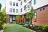 Woodstock, OR, Apartments with Air Conditioner - Novus - A Courtyard with Modern Building Exteriors, Private Patios, Greenery, and Seating.