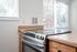 Kitchen with wood cabinets and glass top stove