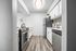 galley kitchen with faux hardwood flooring and stainless steel appliances at peoria grand apartments