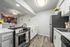 galley kitchen with faux hardwood flooring and stainless steel appliances at peoria grand apartments