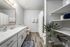 full bathroom with faux hardwood flooring, shelves for storage and large vanity at peoria grand apartments