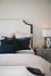 bed with white comforter and blue pillows