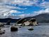 lake with rocks and mountain in the background