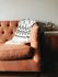 brown sofa with white throw blanket