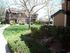 walkway in between grass with two story apartment building in the background at brooktree apartments