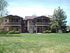 two story apartment building with grassy area in front at brooktree apartments