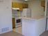 kitchen with vinyl flooring breakfast bar and white appliances at brooktree apartments