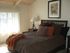 bedroom with bed and side tables and accent pillows at plumas garden apartments