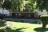 grassy area with bench and patios in the background at plumas garden apartments
