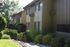 walkway in between grassy area and two story apartment building at plumas garden apartments