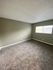 bedroom with brown carpet and green walls at the creek at south carson