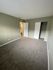 bedroom with brown carpet and green walls at the creek at south carson