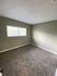bedroom with brown carpet and green walls at the creek at south carson