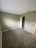 bedroom with brown carpet and green walls and closet with sliding doors at the creek at south carson