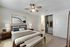 One-Bedroom Apartments in Reno, NV - Redfield Ridge - Furnished Bedroom with Plush Carpeting, a Ceiling Fan, a Large Closet, and a Bathroom