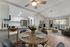 furnished dining area and living room with ceiling fan and wood like flooring at redfield ridge apartments