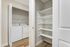 South Reno, NV, Apartments Near University of Nevada - Redfield Ridge - In-Home Laundry Area With Full-Size Washer and Dryer Beside Open Shelving and Neutral Painted Walls.